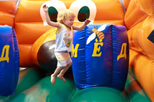 Child jumping on bouncy castle